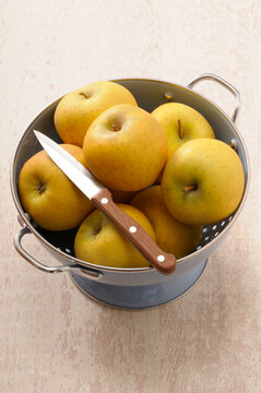 Overhead View of Colander filled with Apples and a Knife, Studio Shot