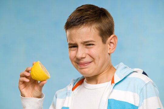 Boy Eating a Lemon