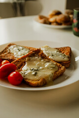 Sandwich with melted cheese. And cherry tomatoes. The quick breakfast of millennials. Morning food.