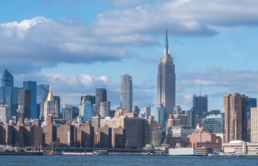 NYC Manhattan skyline buildings in a perfect daylight with clouds in the sky 