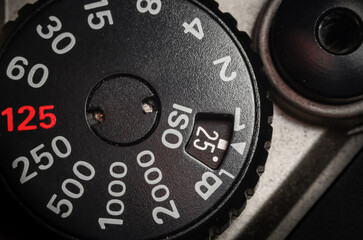 Extreme close up shot of camera mechanical ISO dial. Camera manual settings concept.