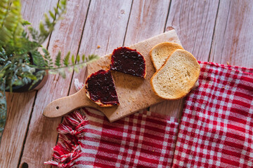 Top view of jam spreading on piece of bread on the table breakfast during the day or in the morning