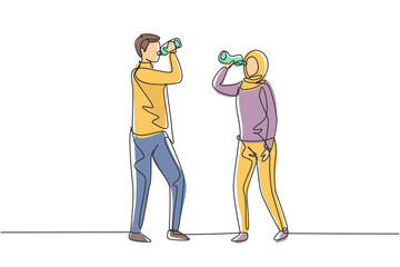 Fototapeta na wymiar Single continuous line drawing couple of Arabian teenagers standing while enjoying a bottle of fresh water after exercise together. Healthy lifestyle. One line draw graphic design vector illustration