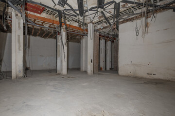 Raw premises with all electrical pipes without finishing in sight and cement floors