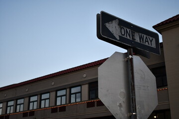 one way sign on top of stop sign