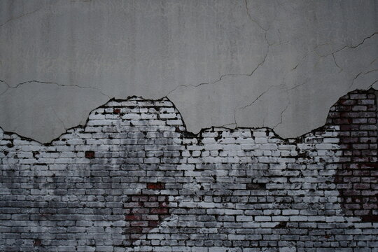 Dark colored brick wall crumbling away slowly.