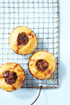 Overhead View of Individual Meat Pies on Cooling Rack, Studio Shot