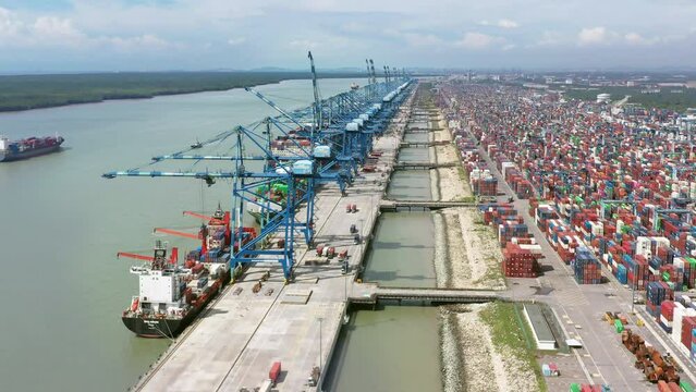 Aerial top view footage of container terminal. Industrial cargo port. Logistic center of the Asian economy.  Container in import export logistic business and international freight transportation. 