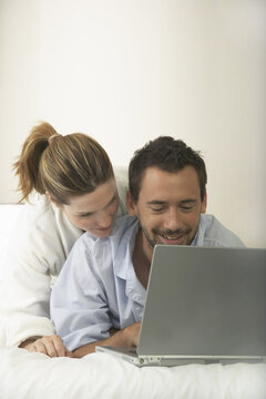 Couple in Bed, Using Laptop