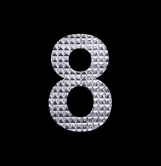 Number eight on textured silver shiny paper