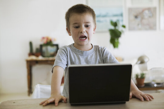 Boy Watching Video on Laptop
