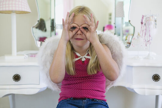 Young Girl Playing Peek-a-Boo with Her Fingers