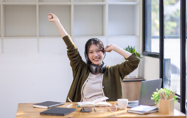 Young adult happy smiling Hispanic Asian girl student wearing headphones talking on online chat...