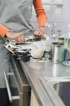 Woman Bundling Recycling