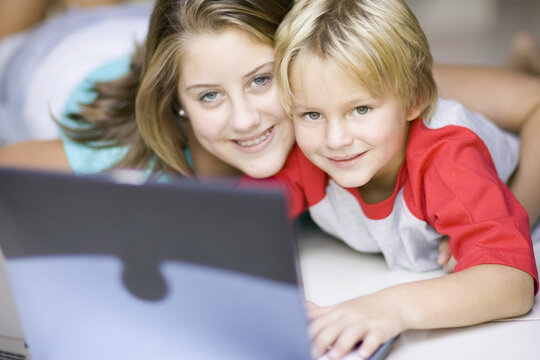 Girl and Boy Using Laptop Computer