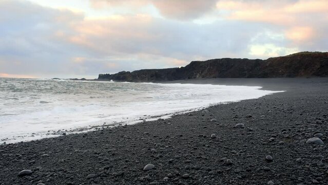 Icelandic Black Sand Beach Coast at Sunset, Volcanic Cliffside with Blue North Atlantic Ocean Water, Shot in 8K Resolution 4320p