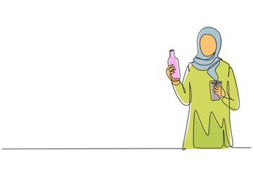 Continuous one line drawing young Arabian woman holding bottle in one hand and glass of orange juice in the other while having breakfast at home. Single line draw design vector graphic illustration