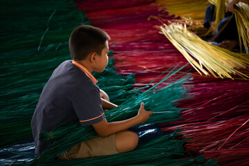 Processing of flax trees into different colors to be weaved into mats.