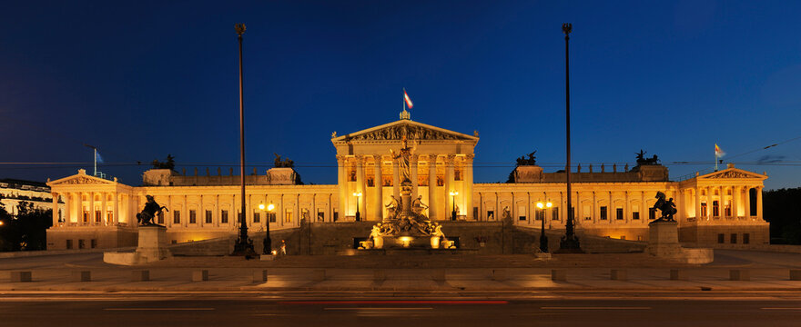 Austrian Parliament and Pallas Athene statue in Vienna illuminated at dusk. Vienna, Austria.