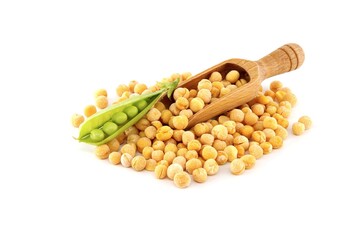 Dry peas spilling from scoop and pea pods over white