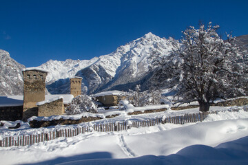 Traditional Svan towers and houses surrounded by the high mountains of the Caucasus, Svaneti,...