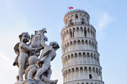 Cherub Statue of Fontana Dei Putti with Leaning Tower of Pisa, Piazza dei Miracoli, Pisa, Tuscany, Italy