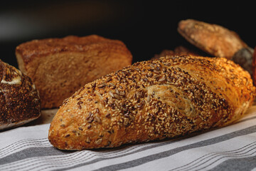 Multigrain sourdough bread with other craft bread in the background