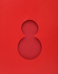 World Women's Day. Hole of red paper in the shape of the number 8