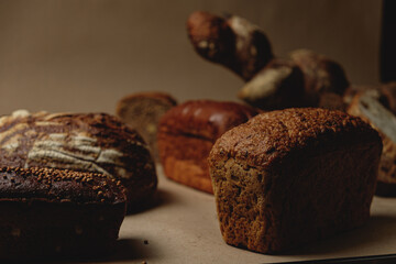 Baguette and different types of sourdough kraft bread on kraft paper background