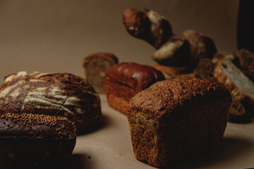 Baguette and different types of sourdough kraft bread on kraft paper background