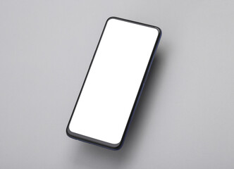 Mockup of a levitating smartphone with a white screen on a gray background
