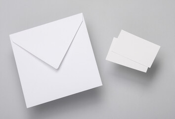 White Blank business cards for branding and envelope on gray background. Creative mockup