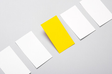 Yelow and white Blank business cards for corporate identity on gray background. Creative mockup. ...