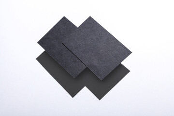 Black Blank business cards for corporate identity with shadow on white background. Creative mockup.