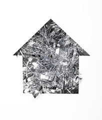 House cut out of paper hole with tinsel on white background