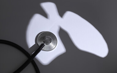 Shadow in the form of human lungs with a stethoscope. Diagnosis of lung diseases