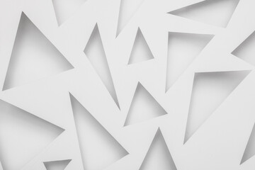 Cut paper in the shape of triangles. Abstract white background