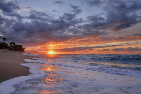 Sunset and surf on the Pacific Ocean at Sunset Beach on Oahu, Hawaii, USA