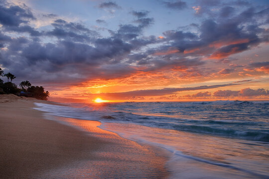 Sunset and surf on the Pacific Ocean at Sunset Beach on Oahu, Hawaii, USA