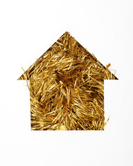 House cut out of paper hole with golden tinsel on white background
