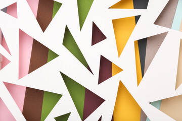 Cut paper in the shape of triangles. Abstract background