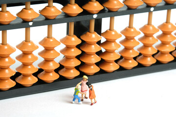 Miniature people toy figure photography. Fun learning concept. Kids play together in front of...