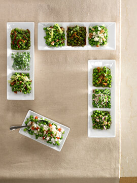 Variety of ways to serve peas in white dishes, studio shot