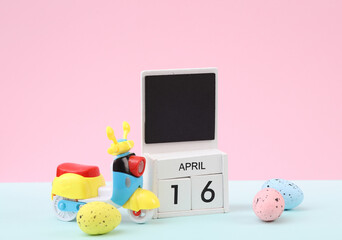 Happy easter. Calendar with date april 16 and easter eggs with moped on pastel background