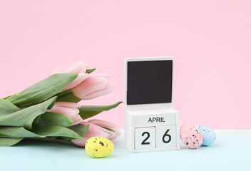 Happy easter. Calendar with date april 26, tulips and easter eggs on pastel background