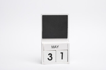 Block wooden calendar with the date may 31 on white background.