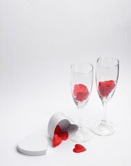Two glasses with hearts and gift box on white background. Valentine's Day, February 14