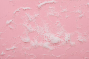 Pink background with foam. Cleaning concept