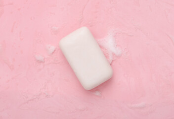 Soap with foam on a pink background. Clean hands, hygiene