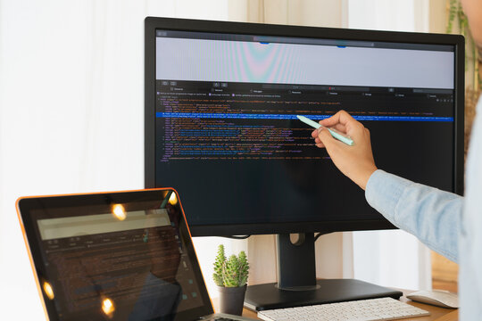 Young asian man programer developer coding software about intelligence innovation. Young man programmer writes program code on a computer. home office .